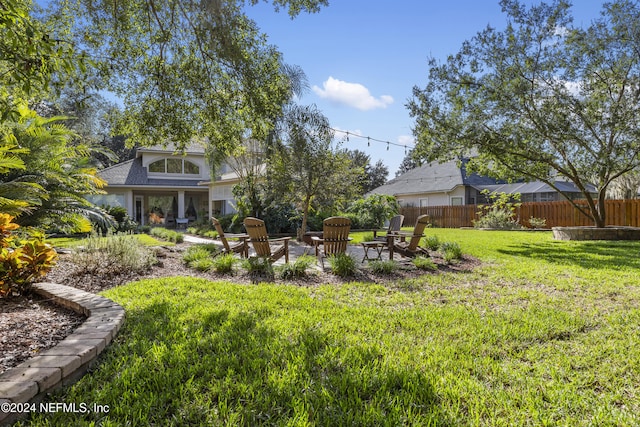 view of yard with an outdoor fire pit