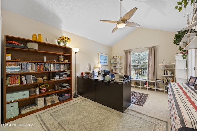 carpeted home office with ceiling fan and lofted ceiling