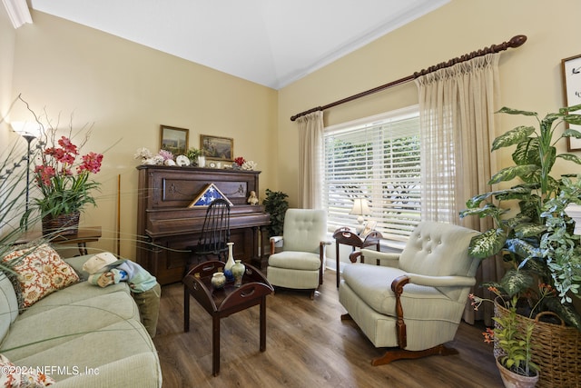 sitting room featuring hardwood / wood-style flooring, lofted ceiling, and crown molding