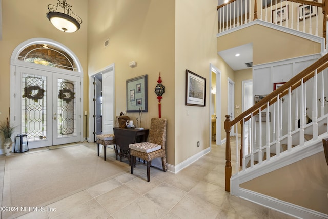 foyer entrance with french doors and a high ceiling