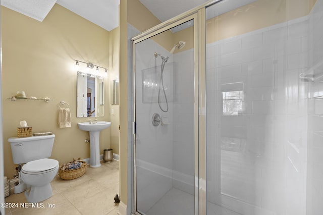 bathroom with toilet, an enclosed shower, and sink