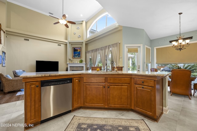 kitchen with dishwasher, ceiling fan with notable chandelier, hanging light fixtures, and plenty of natural light