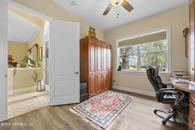 office area with vaulted ceiling, light hardwood / wood-style flooring, and ceiling fan