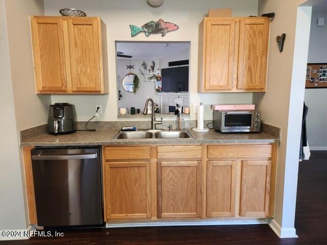 kitchen with dishwasher, sink, light brown cabinetry, and dark wood-type flooring