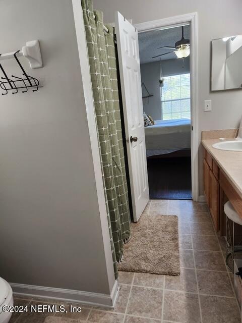 bathroom with ceiling fan, vanity, and toilet