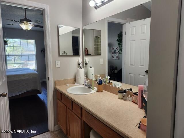 bathroom featuring tile patterned floors, ceiling fan, and vanity