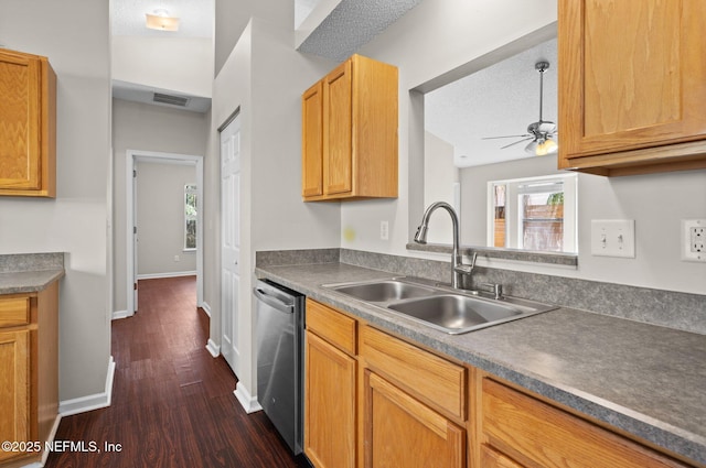 kitchen featuring ceiling fan, dishwasher, sink, dark hardwood / wood-style flooring, and a textured ceiling