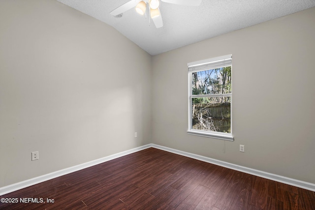 unfurnished room featuring vaulted ceiling, a ceiling fan, baseboards, and dark wood-style flooring