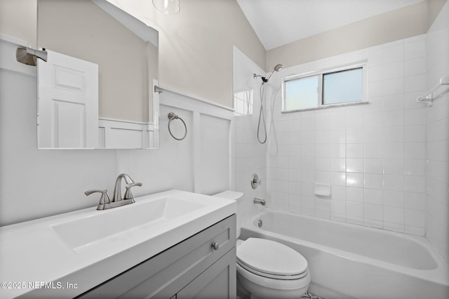 full bathroom featuring tub / shower combination, toilet, wainscoting, and vanity