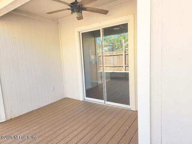 wooden terrace featuring a ceiling fan