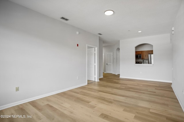 spare room with light hardwood / wood-style floors