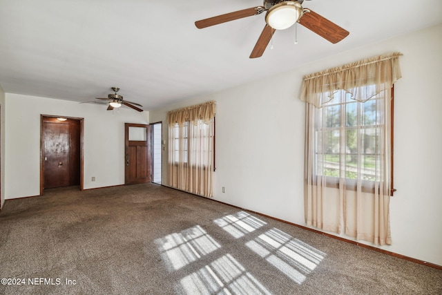 unfurnished living room with ceiling fan and carpet