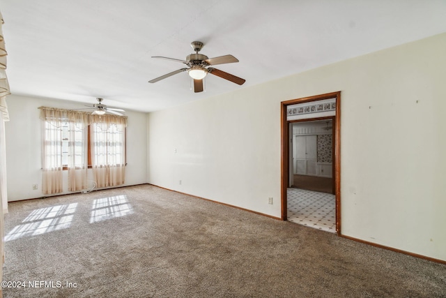 carpeted empty room featuring ceiling fan