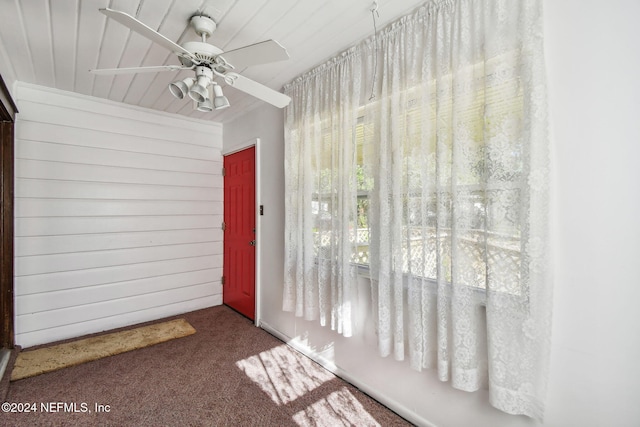 interior space with ceiling fan