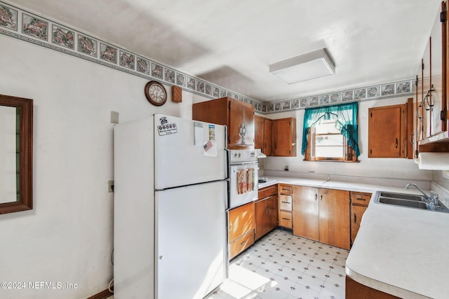 kitchen with sink and white appliances