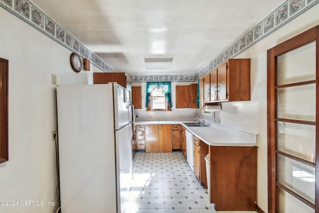 kitchen with white appliances and sink