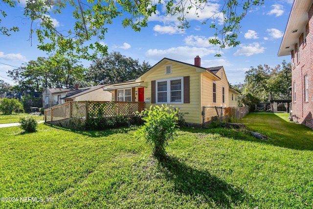 view of front of property with a front yard and a deck