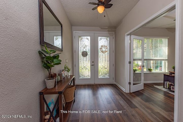 entrance foyer with french doors, a textured ceiling, dark hardwood / wood-style flooring, and ceiling fan