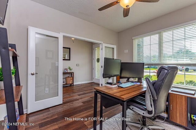 home office featuring ceiling fan, a healthy amount of sunlight, dark hardwood / wood-style floors, and french doors