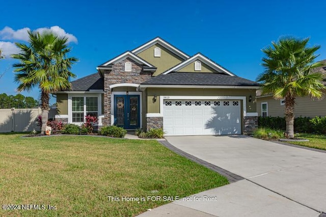 craftsman house featuring french doors, a front yard, and a garage