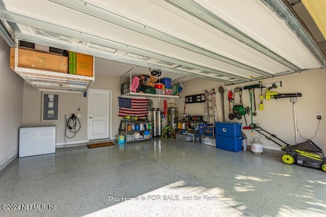 garage with refrigerator and electric panel