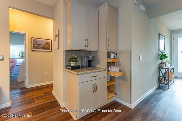 kitchen with backsplash, white cabinetry, plenty of natural light, and dark hardwood / wood-style floors