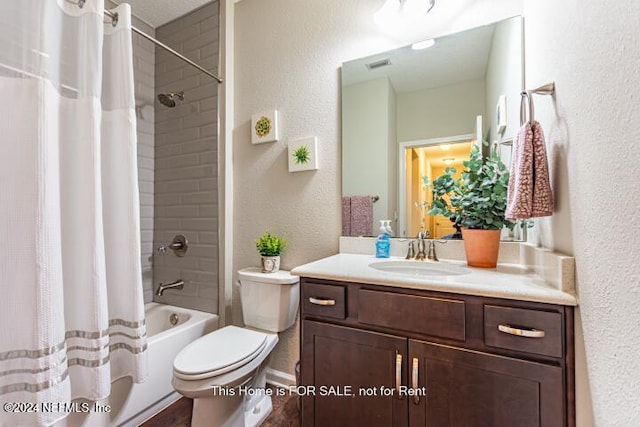 full bathroom with shower / tub combo, vanity, and toilet