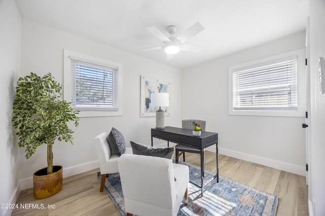 home office featuring ceiling fan and light hardwood / wood-style floors