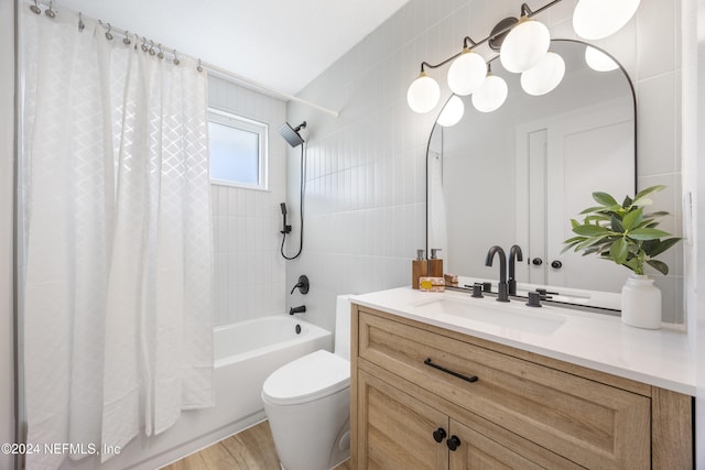 full bathroom with vanity, shower / bath combo with shower curtain, hardwood / wood-style flooring, tile walls, and toilet