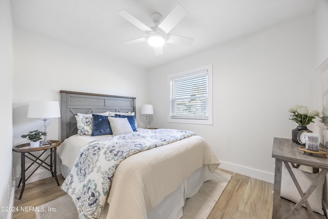 bedroom with ceiling fan and light hardwood / wood-style flooring