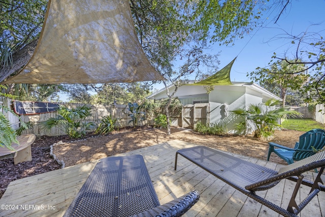 wooden deck with a storage shed