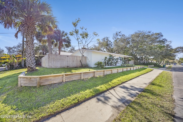 view of property exterior featuring a lawn