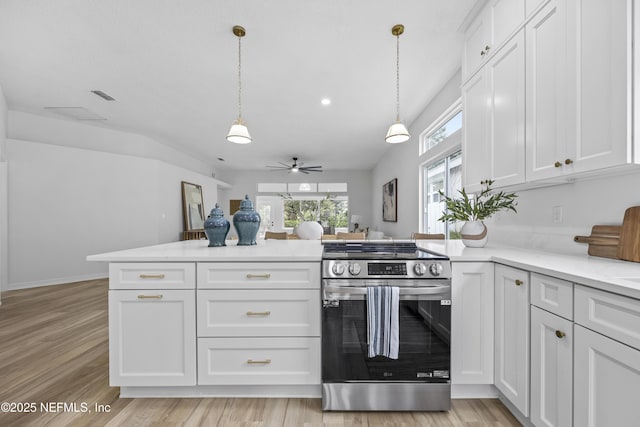 kitchen with stainless steel range, white cabinets, and decorative light fixtures