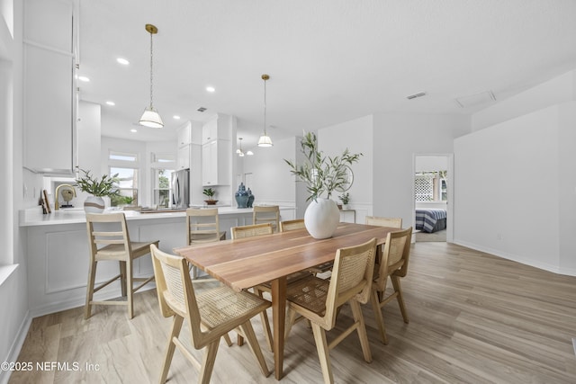 dining space featuring light hardwood / wood-style floors