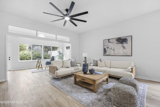 living room featuring light hardwood / wood-style floors and ceiling fan