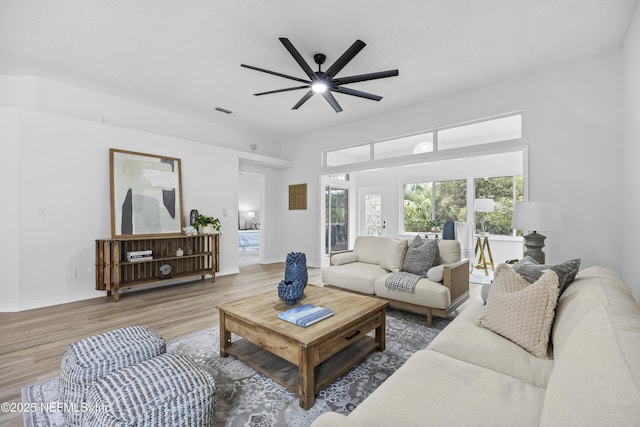 living room featuring wood-type flooring and ceiling fan