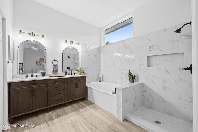 bathroom with shower with separate bathtub, vanity, and wood-type flooring