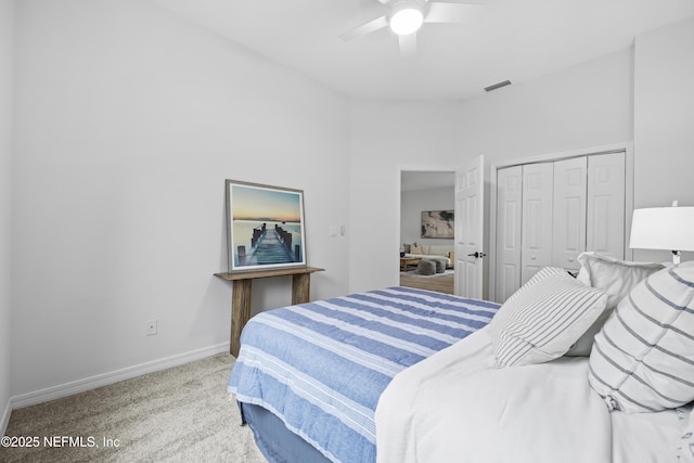 carpeted bedroom featuring a closet and ceiling fan