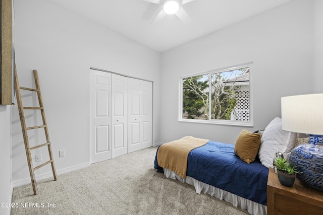 carpeted bedroom with ceiling fan and a closet