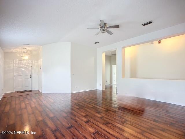 empty room with dark hardwood / wood-style flooring and ceiling fan