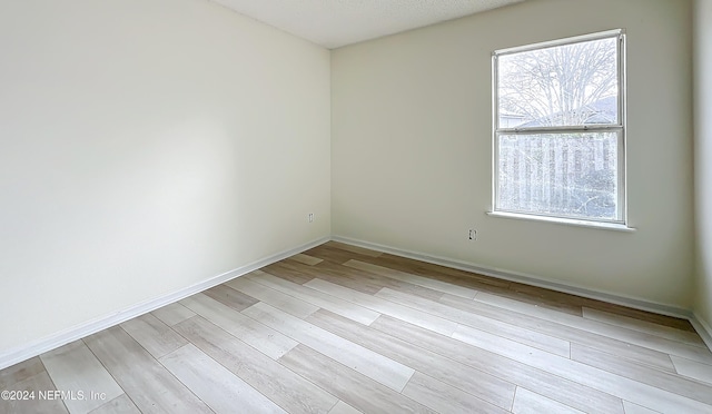 spare room with light hardwood / wood-style floors