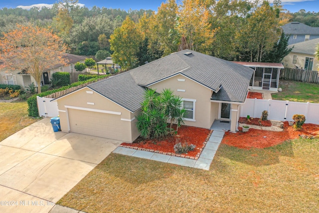 view of front of property with a sunroom and a front yard