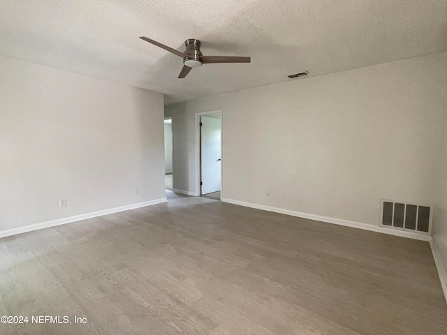 unfurnished room featuring wood-type flooring, a textured ceiling, and ceiling fan