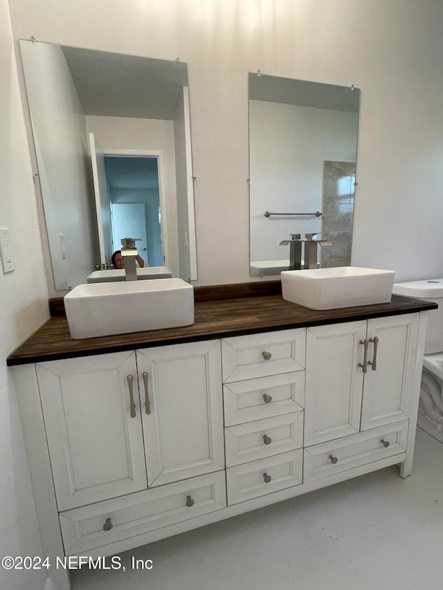 bathroom featuring vanity and concrete flooring