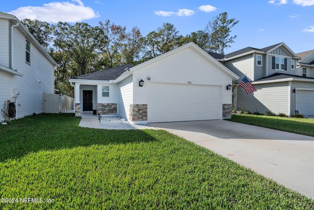 view of front of home featuring a front lawn and a garage