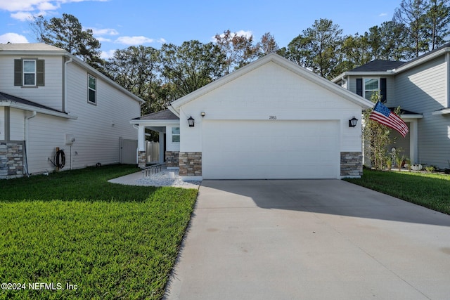 view of front of home with a front lawn and a garage