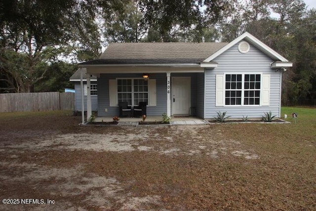 view of front of house with covered porch and a front yard