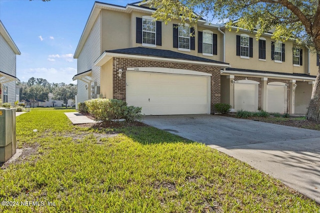 view of front of house with a front yard and a garage