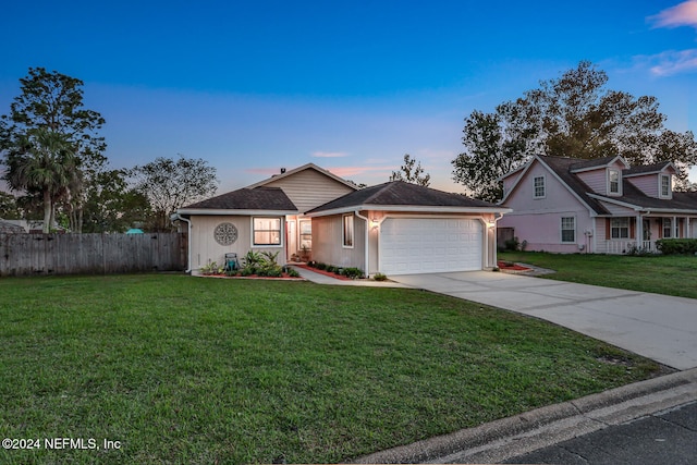 view of front of house featuring a yard and a garage