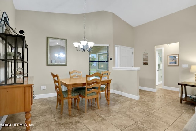 dining area featuring high vaulted ceiling and an inviting chandelier